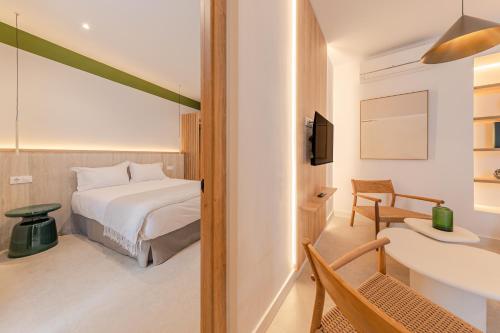 a bedroom with a bed and a desk and a sink at Green House in Seville