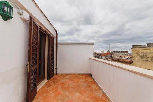 a balcony with an open door on a white building at Don Ciccio Apartments&Suite in Conversano