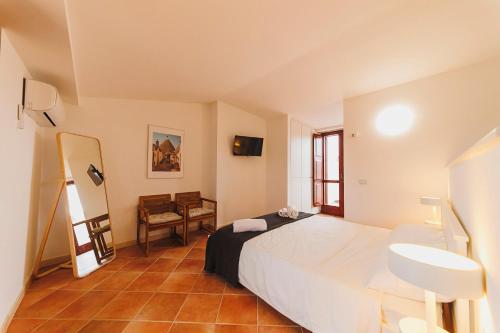 a bedroom with a large white bed and a sink at Don Ciccio Apartments&Suite in Conversano