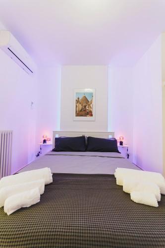 a bedroom with a large bed with two white pillows at Don Ciccio Apartments&Suite in Conversano