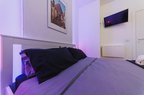 a bedroom with a bed with purple sheets at Don Ciccio Apartments&Suite in Conversano