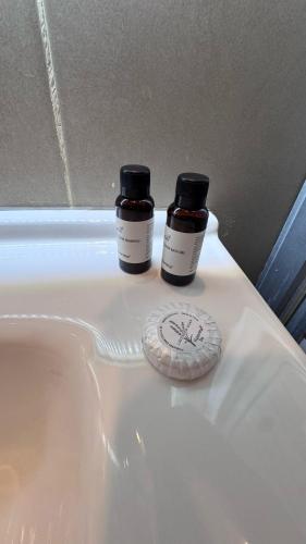 two bottles of medicine sitting on top of a sink at يزن للاجنحة الفندقية in Aqaba