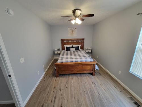 a bedroom with a bed and a ceiling fan at The Third Monkey in Williamstown