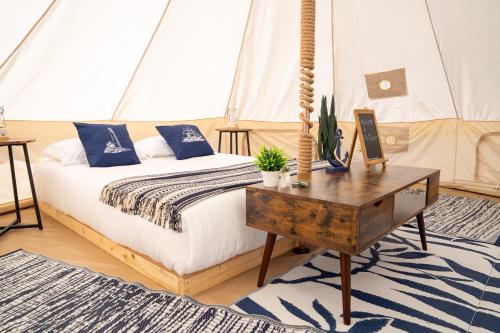 a bedroom with a bed and a table with a table at Grotto Getaway in Miller Lake