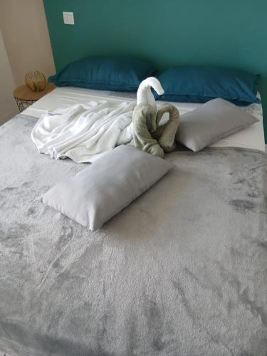 a stuffed animal sitting on top of a bed at L'Odysea Résidence de la baie in Les Trois-Îlets