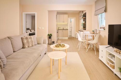 a living room with a couch and a table at Apartments Martello Garden in Poreč