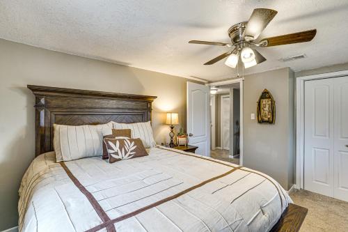 a bedroom with a large bed with a ceiling fan at Truman Lake Retreat Large Deck and On-Site Fishing! in Clinton