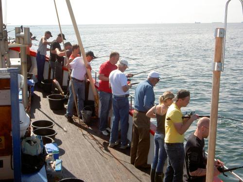 a group of people standing on the deck of a boat at Mötesplats Borstahusen in Landskrona