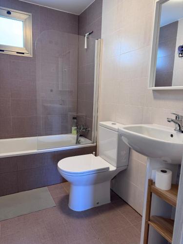a bathroom with a white toilet and a sink at Rosalia28 in Antigua