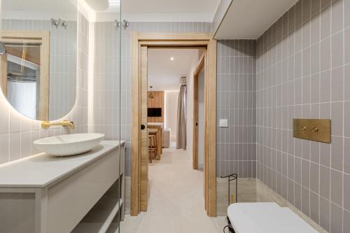 a bathroom with a sink and a mirror at Green House in Seville