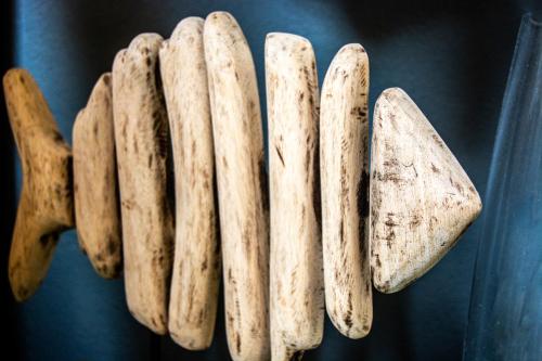 a group of wooden objects hanging on a wall at Long Beach Selfcatering Namibia in Langstrand