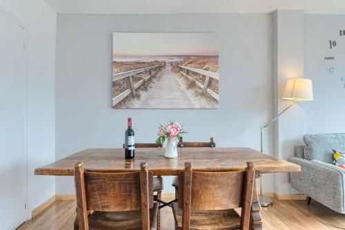 a dining room with a table with a bottle of wine at Coast & Beach View Parking in Bakio