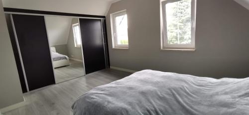 a bedroom with a bed and a large mirror at Willa Prądocin nad Jeziorem Jezuickim in Prądocin