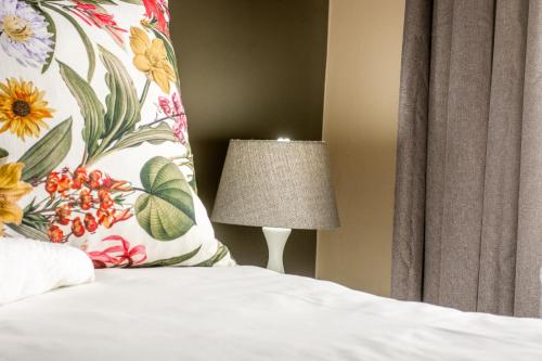 a bedroom with a bed with a pillow and a lamp at Long Beach Selfcatering Namibia in Langstrand