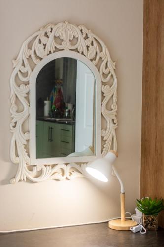 a mirror on a wall with a lamp at Long Beach Selfcatering Namibia in Langstrand