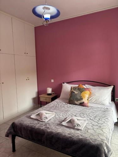 a bedroom with a bed with two towels on it at FIGALIA Apartments in Kavala