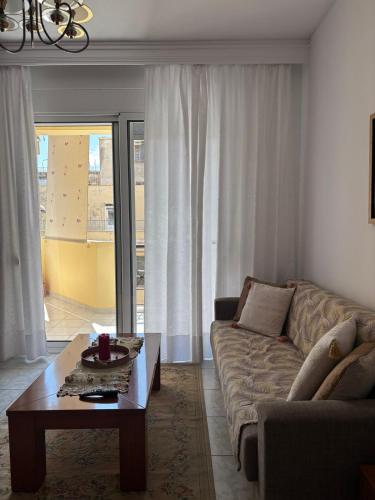 a living room with a couch and a coffee table at FIGALIA Apartments in Kavala