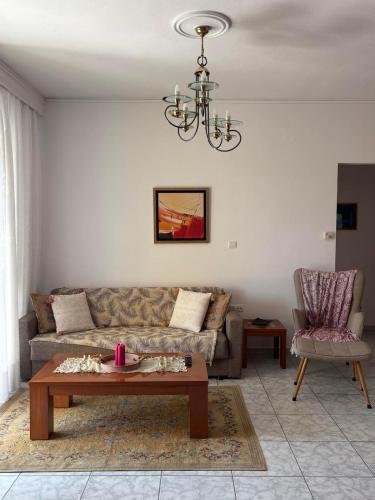 a living room with a couch and a table at FIGALIA Apartments in Kavala