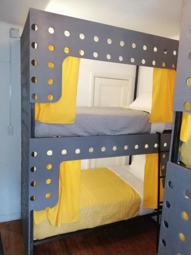 a couple of bunk beds with yellow cushions at RMS Hostal - Condesa in Mexico City