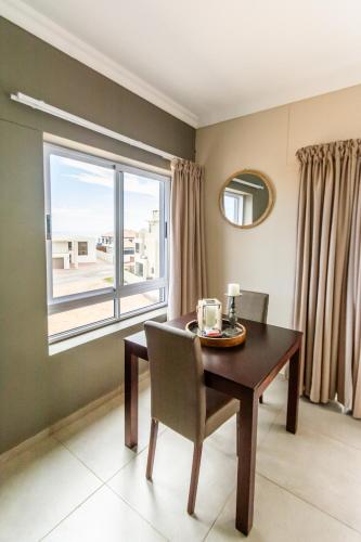 a dining room with a table and a window at Long Beach Selfcatering Namibia in Langstrand