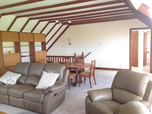 a living room with a couch and a table at Stow House in Berwick-Upon-Tweed