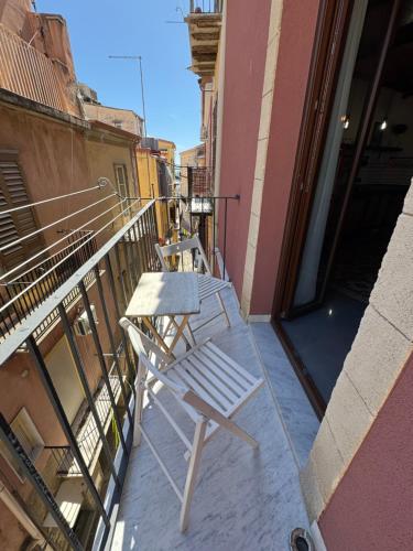 a white chair sitting on the balcony of a building at Appartamento Porto Marina S G 2 in Licata