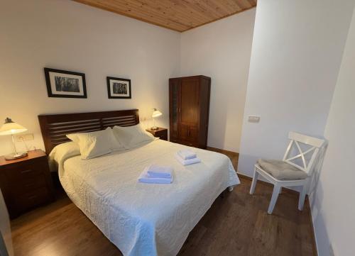 a bedroom with a bed with two towels on it at APARTAMENTOS RioMonte 4 in Margudgued