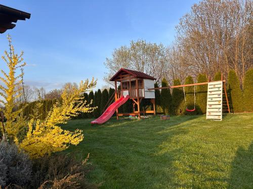 a playground with a slide and a play house at Sielanka Chwaliszów dom całoroczny in Chwaliszow