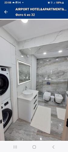 a bathroom with a sink and a washing machine at Жуляны in Chişinău