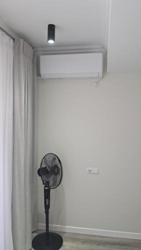 a fan in a room next to a window at Жуляны in Chişinău
