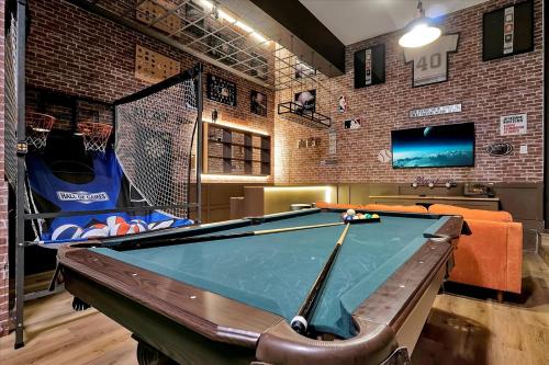 a billiard room with a pool table and a tv at Epic Orlando Mansion-Pool-Game Room-Theater-2 in Orlando