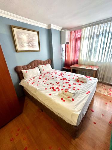 a bedroom with a bed with red roses on it at Cendere Old City Hotel in Istanbul