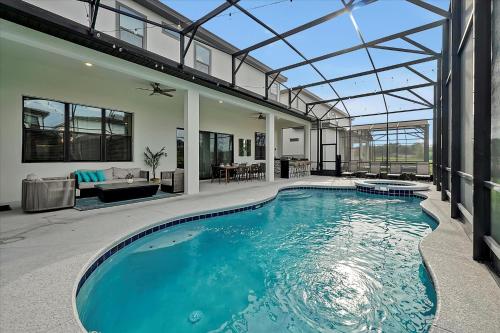 a swimming pool in a house with a glass ceiling at Epic Orlando Mansion-Pool-Game Room-Theater-2 in Orlando