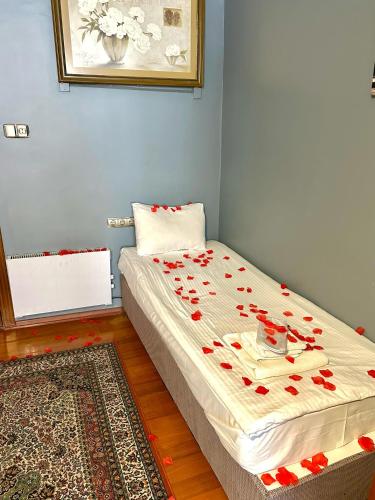 a bed with red roses on it in a room at Cendere Old City Hotel in Istanbul