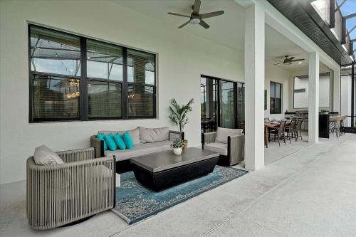 a living room with a couch and a table at Epic Orlando Mansion-Pool-Game Room-Theater-2 in Orlando