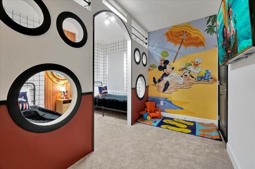 a room with a wall with a mickey mouse mural at Epic Orlando Mansion-Pool-Game Room-Theater-2 in Orlando