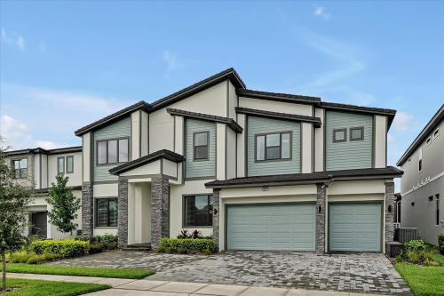 a large house with two garages at Epic Orlando Mansion-Pool-Game Room-Theater-2 in Orlando