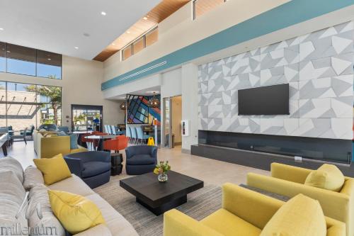 a living room with a couch and a tv at Epic Orlando Mansion-Pool-Game Room-Theater-2 in Orlando