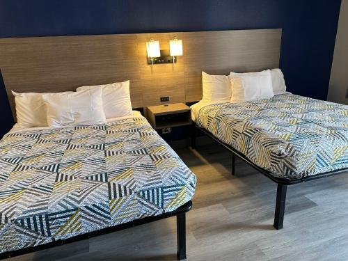 a hotel room with two beds in a room at Studio Suites Extended Stay Chattanooga in Silverdale