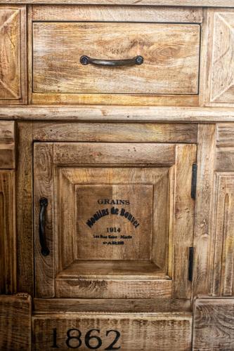 a wooden cabinet with a drawer with a sign on it at Long Beach Selfcatering Namibia in Langstrand