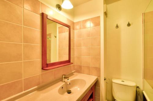 une salle de bain avec un lavabo, des toilettes et un miroir dans l'établissement La résidence du Lac - maeva Home - Maison 3 pièces 6 personnes - Sélection MAE-4081, à Monflanquin