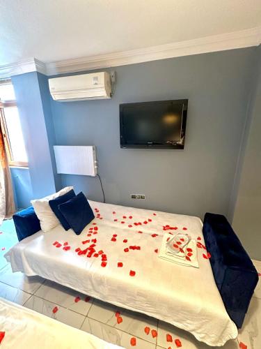 a bedroom with a bed with red roses on it at Cendere Old City Hotel in Istanbul