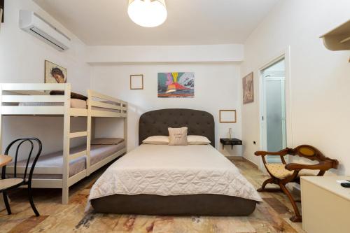 a bedroom with two bunk beds and a desk at L'Anfiteatro di Pompei B&B in Pompei