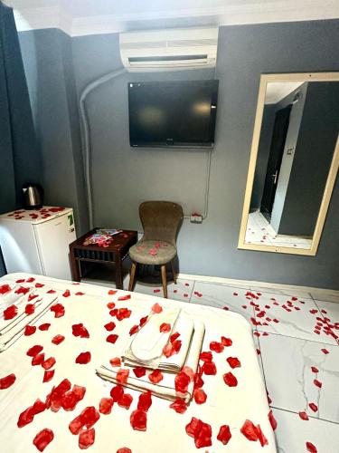a bedroom with red rose petals on a bed at Cendere Old City Hotel in Istanbul