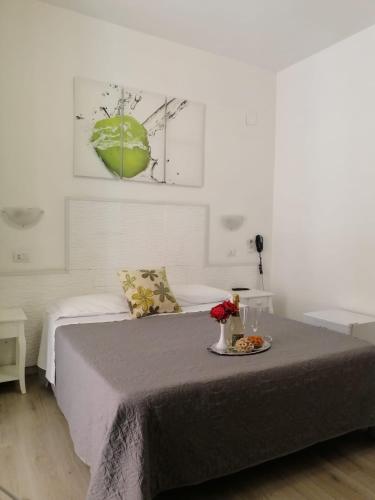 a bedroom with a bed with a tray of food on it at Hotel Birillo in La Spezia
