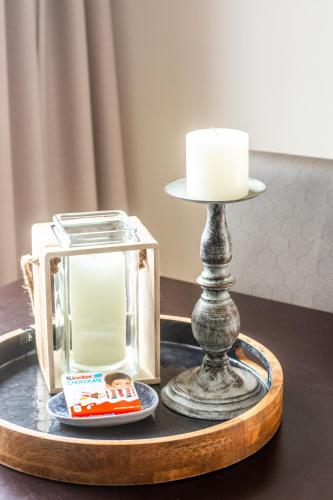 a candle and a lantern on a table at Long Beach Selfcatering Namibia in Langstrand