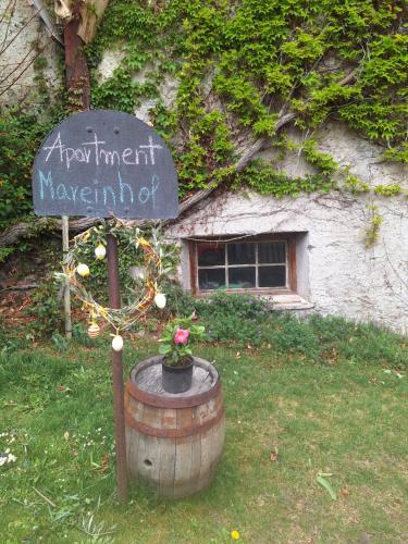 a sign in front of a barrel with a window at Mareinhof Vetzan-Apples,apartment&more in Silandro