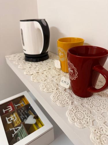 a counter with two cups and a coffee mug at Coro & Bentu in Alghero
