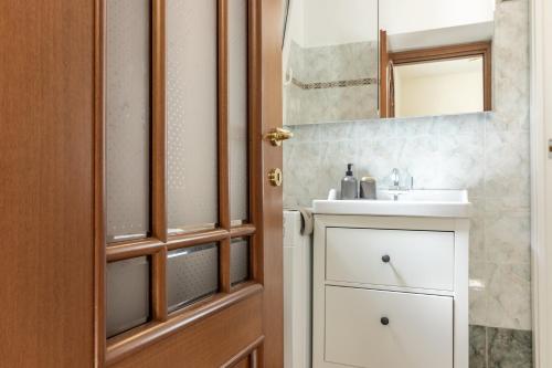 a bathroom with a sink and a mirror at Giadera penthouse 5terreparco in Riomaggiore