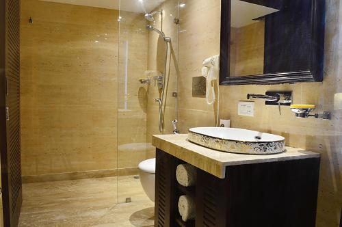 a bathroom with a sink and a toilet and a shower at Hotel Emperor Palms 2Min walk from Karol Bagh metro station in New Delhi